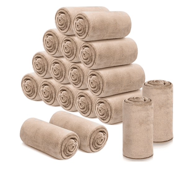 A pile of rolled up towels sitting next to each other.